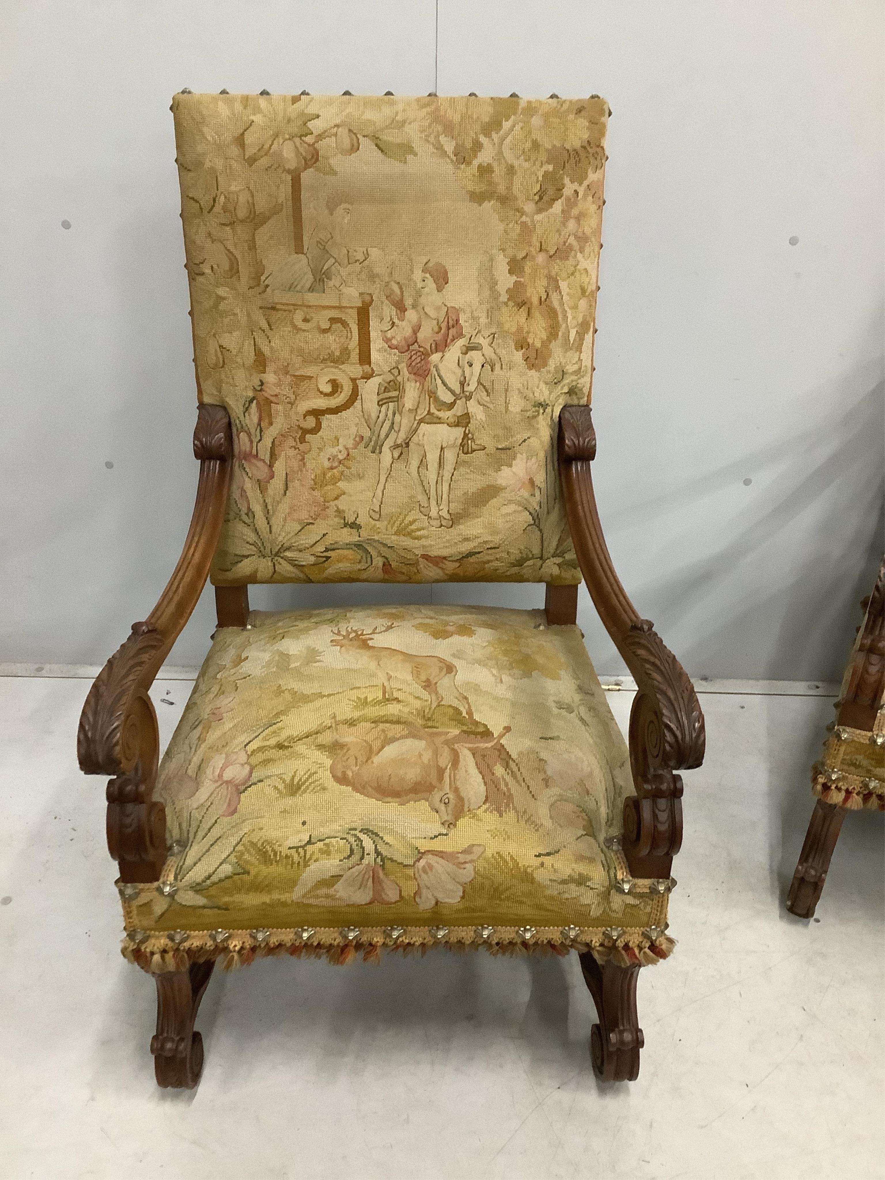 A pair of 18th century style walnut and needlepoint tapestry chairs, width 63cm, depth 64cm, height 114cm. Condition - fair